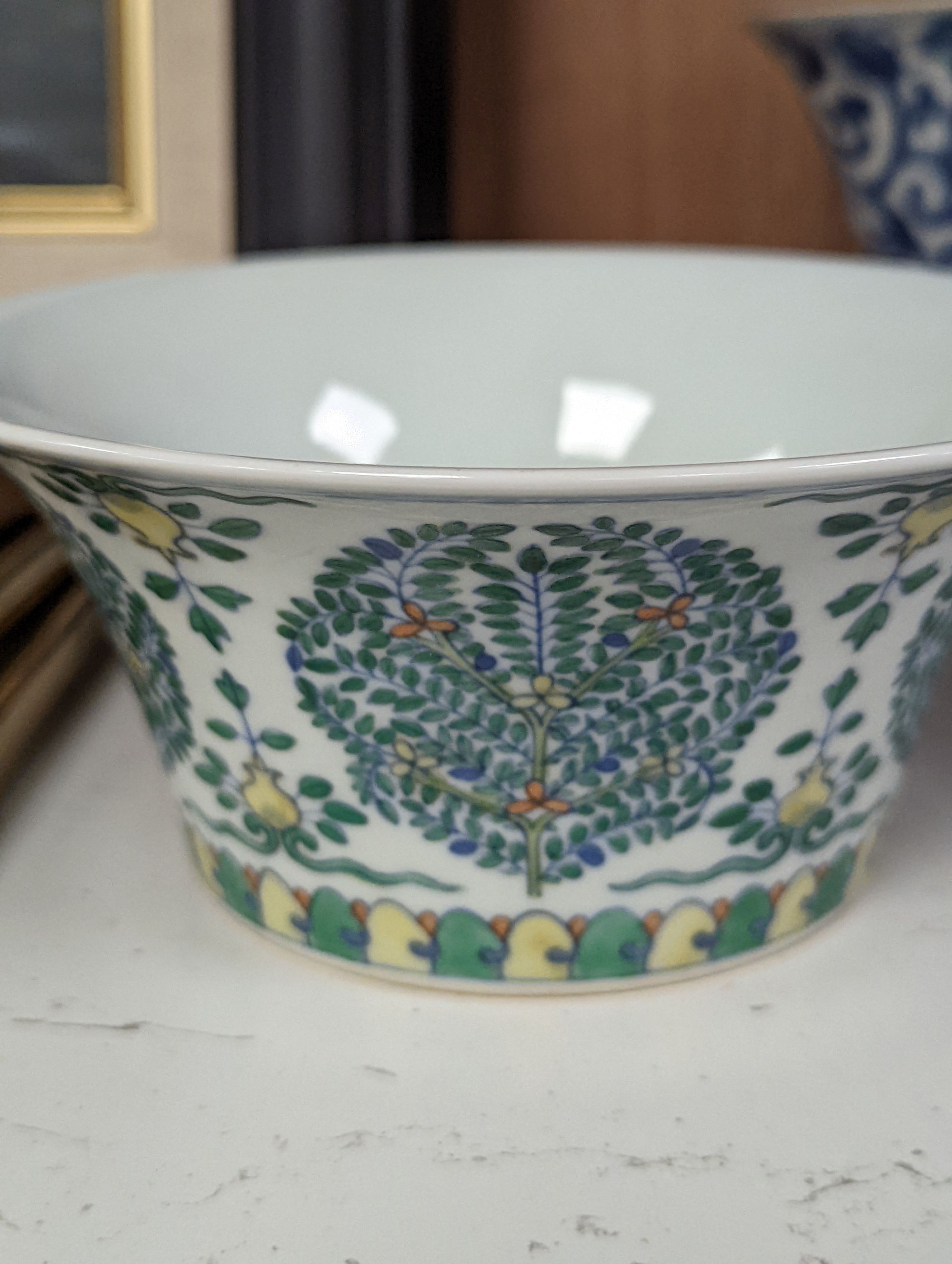 A Chinese blue and white bowl, Kangxi, 15cm. diam., a famille rose teapot stand, Yongzheng, and two doucai bowls